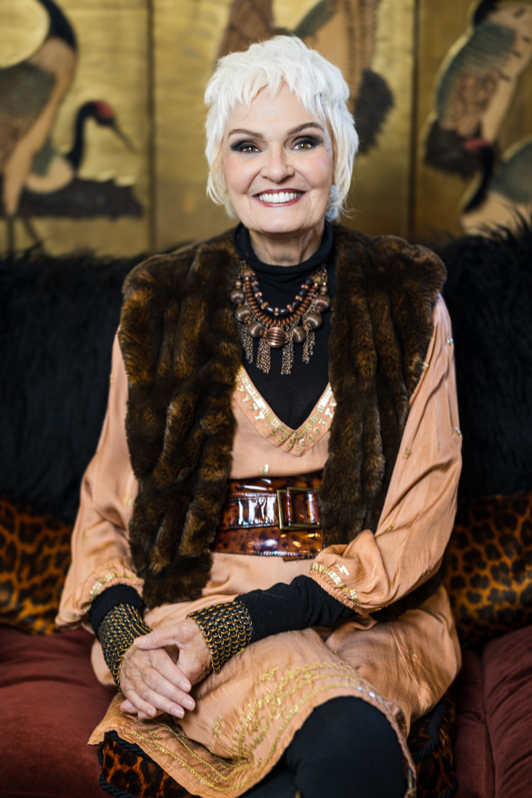 Jennifer Butler in brown fur and gold
