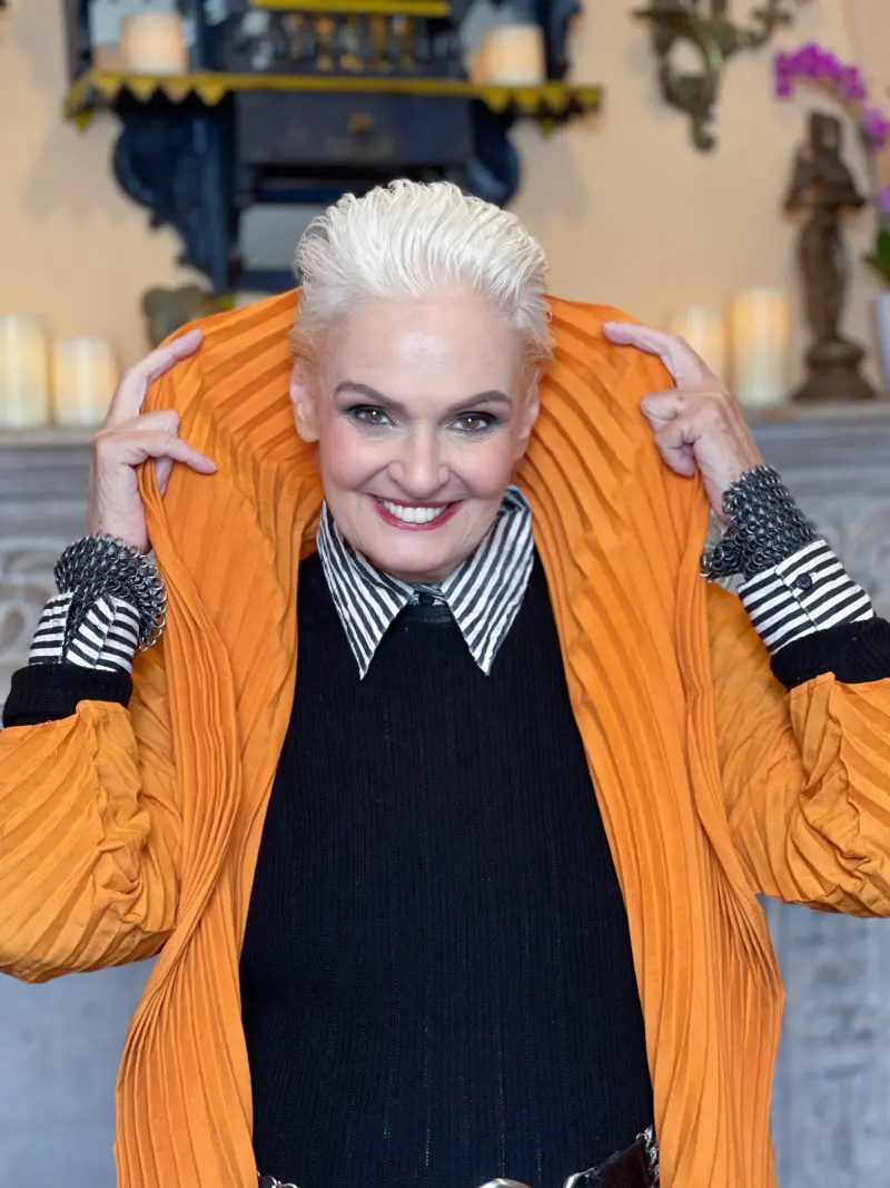 Jennifer Butler, Color DNA oracle, in an orange pleated jacket